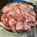A bowl full of sliced rabbit meat.