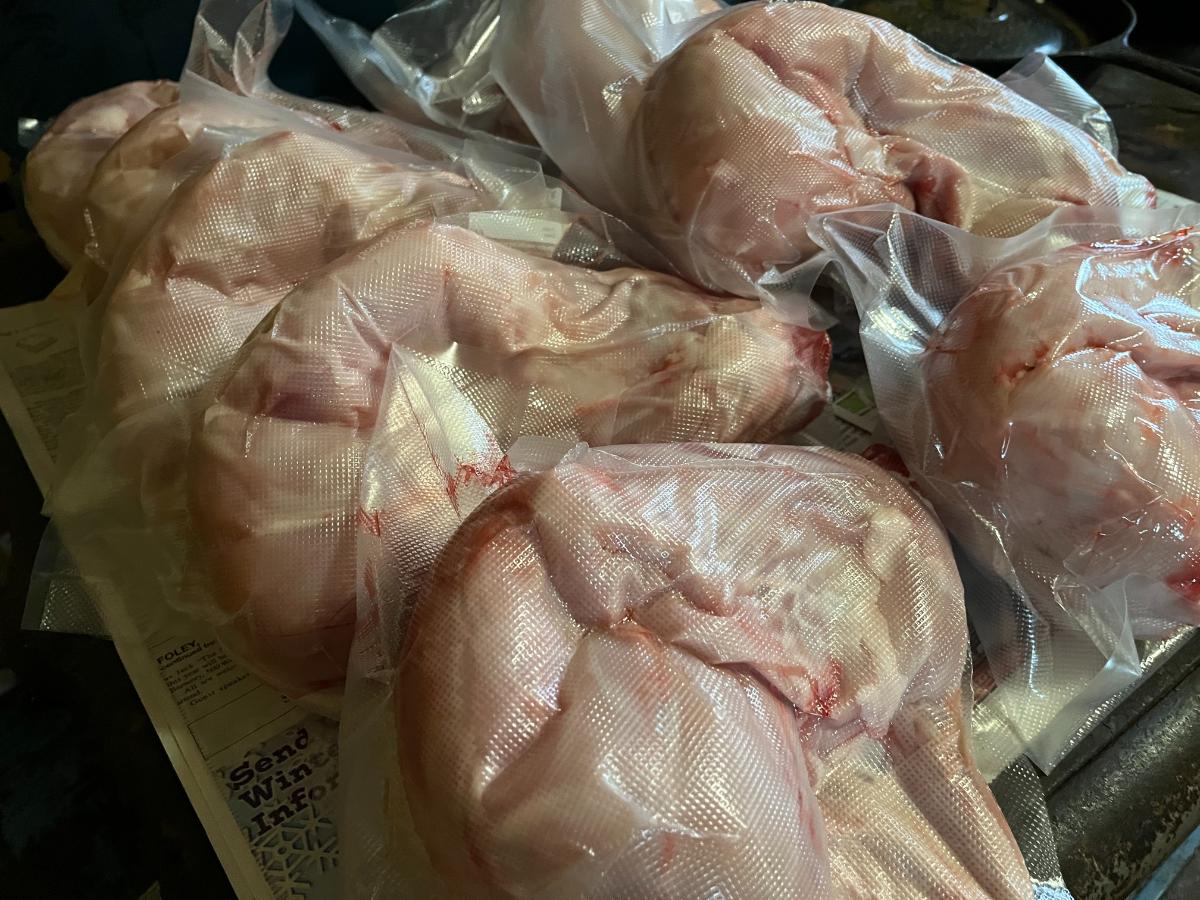 Vacuum-sealed rabbit parts on table